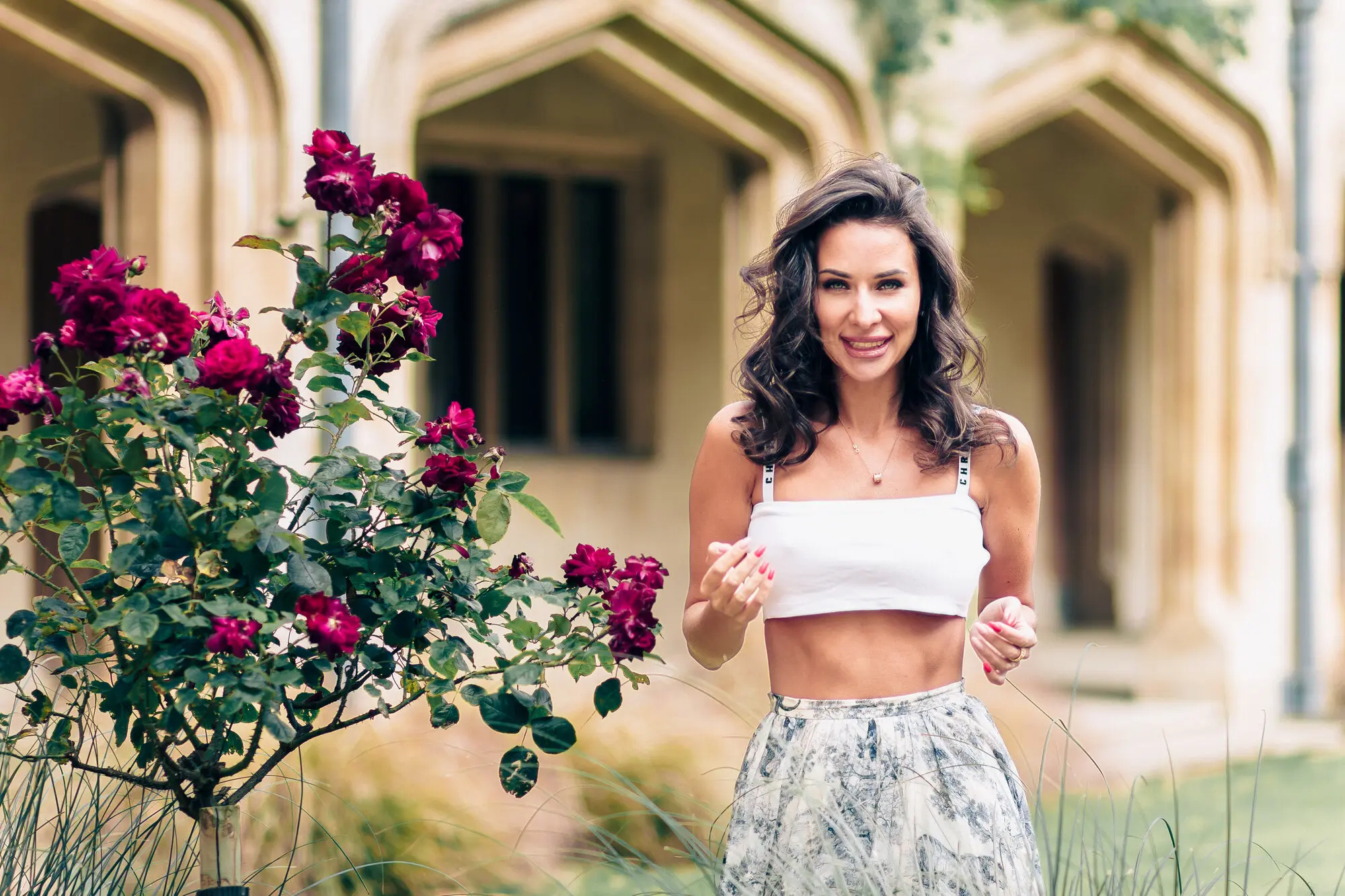 Woman laughing in a rose garden at Magdalen College, captured during an Oxford portrait photography session