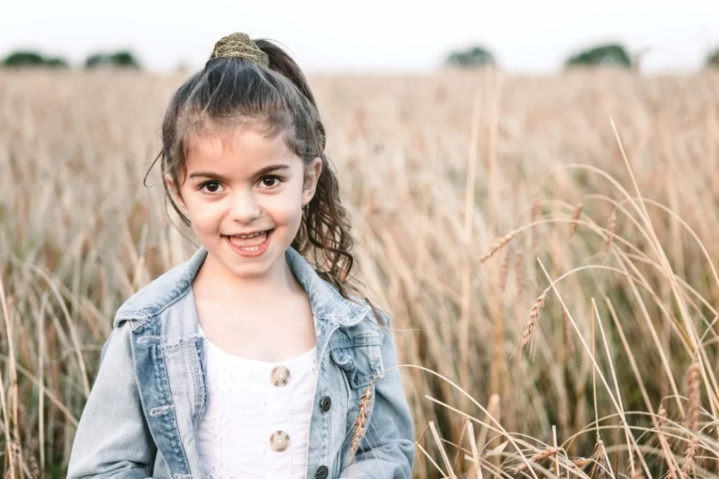 Smiling young girl portrait in a wheat field, Oxford children photographer