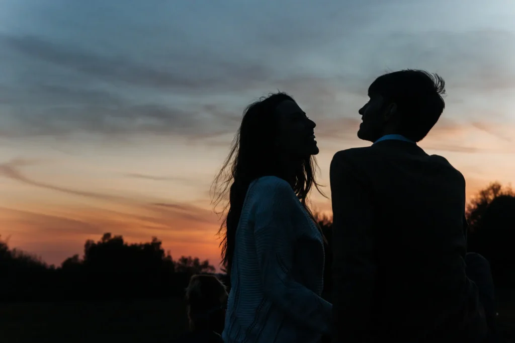 Silhouette of an engaged couple facing each other at sunset, Oxford engagement photography