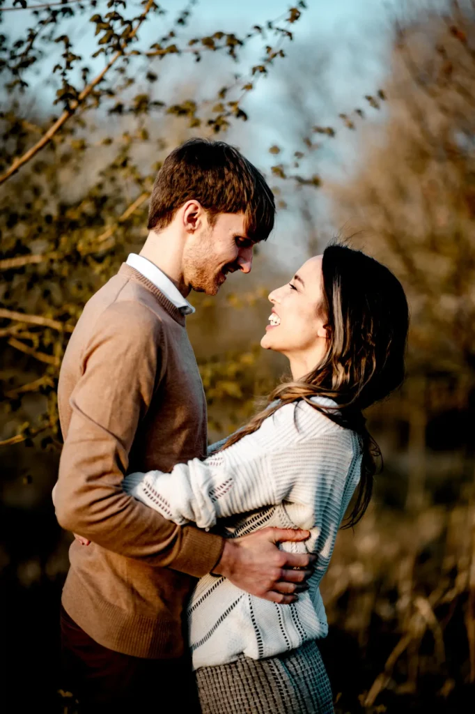 Couple laughing face to face in profile during an Oxfordshire engagement photoshoot