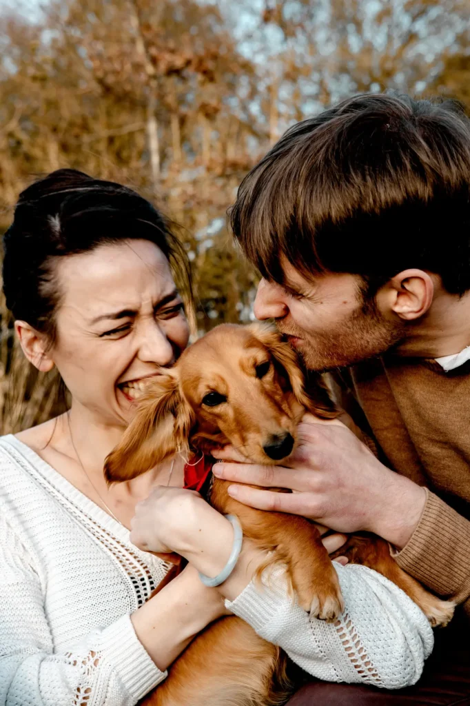 Engaged couple cuddling their dachshund puppy during an Oxfordshire engagement shoot