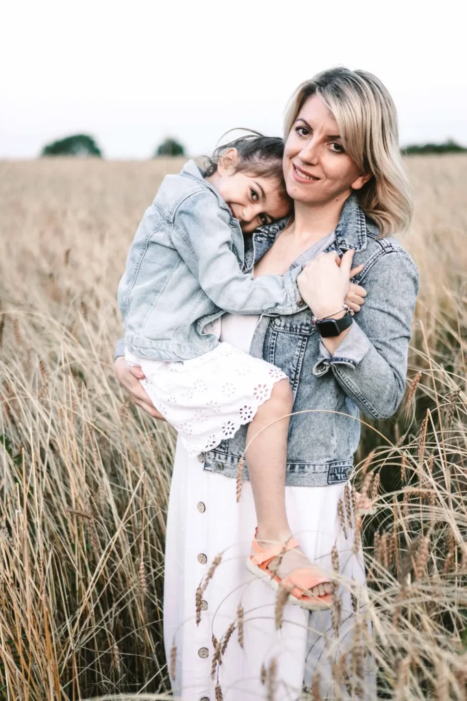 Mother holding her daughter close in a candid moment, Oxford family photography