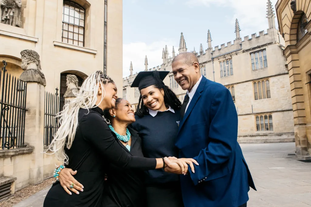 Graduate sharing a joyful family hug outside the Bodleian Library in Oxford