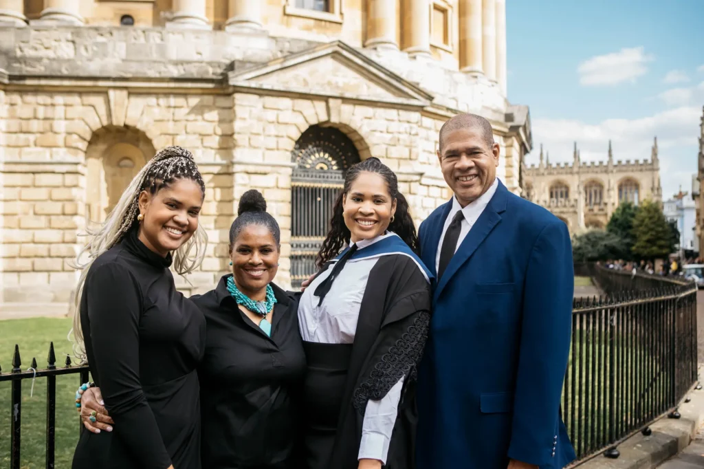 Family celebrating graduation at the Radcliffe Camera with All Souls College behind